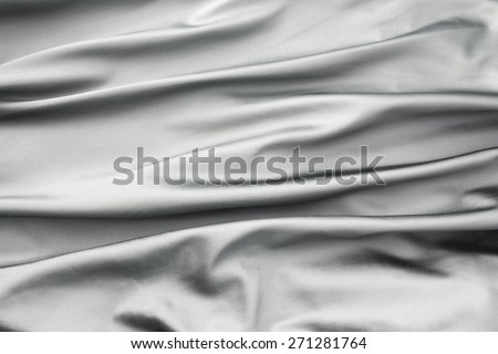 Soft velvet piece of silver fabric with folds to be used as background or overlay