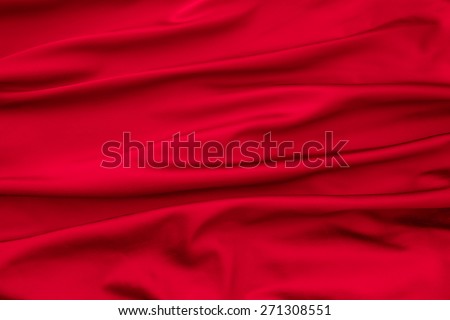 Soft velvet piece of red fabric with folds to be used as background