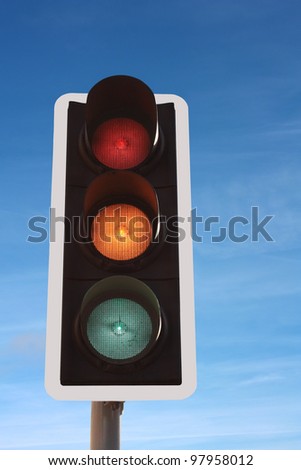 Traffic Lights red amber/orange green against blue sky
