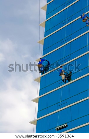 Window washers cleaning the exterior of a residential building