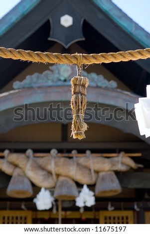 Outside a Japanese temple detailing the Shimenawa rope bundle to prevent evil spirits from entering