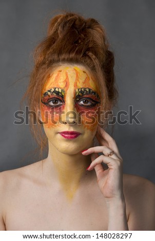 Art body art unusual make-up on her face
