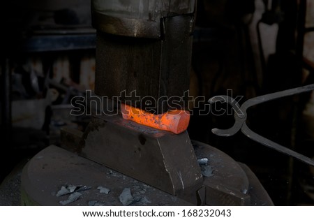 Molten metal in the smithy on the anvil