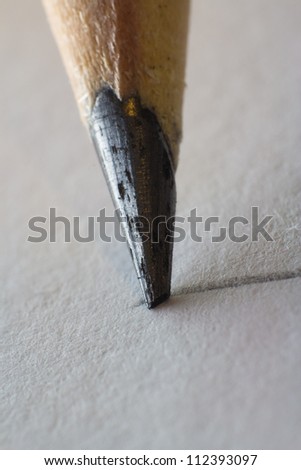 Graphite Pen Point  on a Paper Sheet extreme closeup, the graphite is only couple of millimeters long