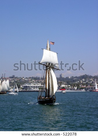 old world style ship sailing in harbor