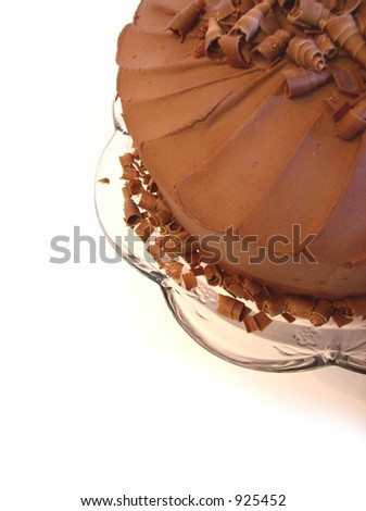 chocolate mousse cake with spiral chocolate shavings on top in corner