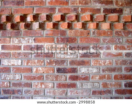 brick wall with an accent pattern in the top