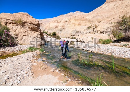 Man crossing the creek in  Wadi Hasa in Jordan