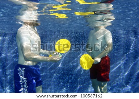 A picture two young men playing underwater