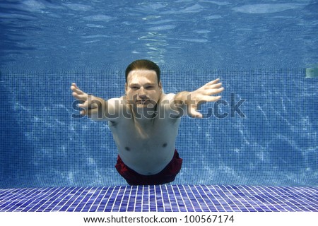 Underwater picture of a young man swimming.