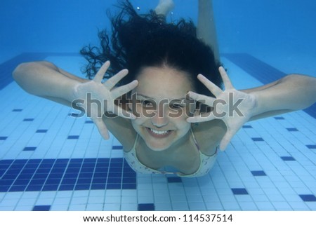 Underwater picture of a girl swimming and playing with joy