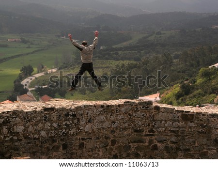 Man jumping in the air (in a castle), inspiring freedom.
