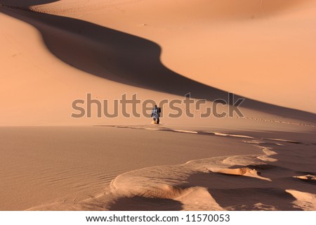 Young man walking alone on the desert.