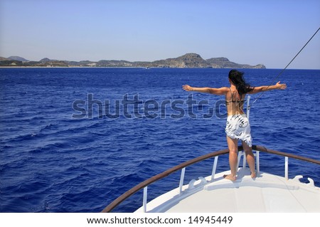 Woman enjoying a sunny summer day on a boat; position inspires freedom.
