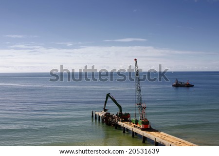 Excavator and other equipments being used (to fix problems) on the beach