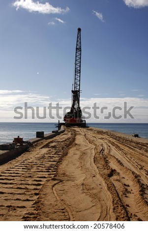 Excavator and other equipments being used (to fix problems) on the beach