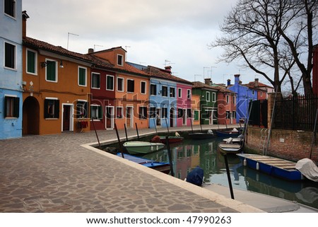 Colorful houses along one of the waterways of Burano, Venice. colorful houses on the island of Burano, off of Venice.