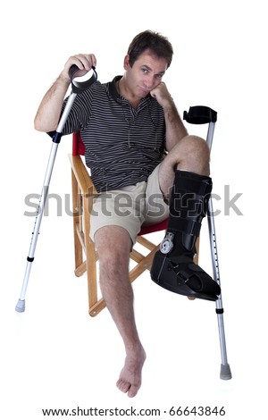 stock photo Mature man with broken legs with crutches and showing a 