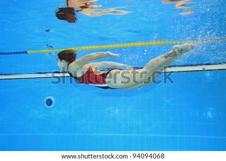 Underwater picture of a young woman swimming.