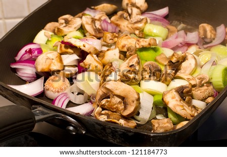 Mushrooms, Leeks and red onions frying in a pan