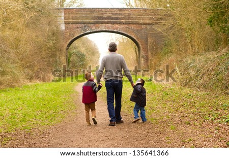 Children Walking With Their Father