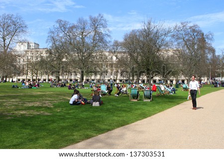 LONDON -APRIL 24: Tourists visit St James Park on 24th April 2013. This was one of the warmest days of the year so far in England\'s capital city