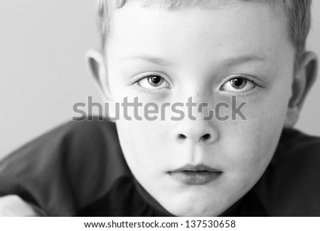 little boy with sad expression and watery eyes