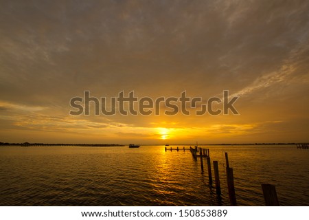 sunset at a weathered pier at port charlotte harbor, near punta gorda,  southwest florida