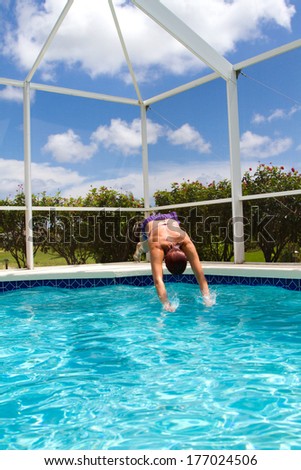 Woman diving into a small pool in the summer