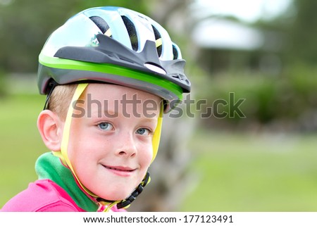 Young Boy wearing a cycling helmet about to go for a bike ride