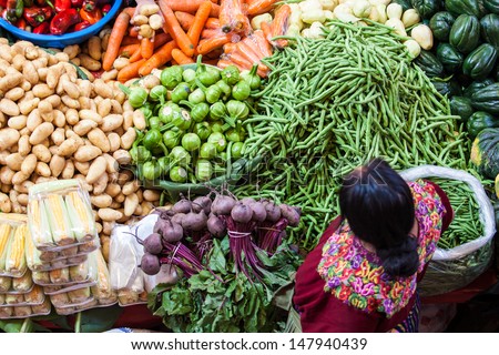 Chichicastenango, Guatemala- May 9: An Unidentified Woman Sells Vegetables At Traditional Weekly Market In Chichicastenango (Chichi), Guatemala On 9 May 2013