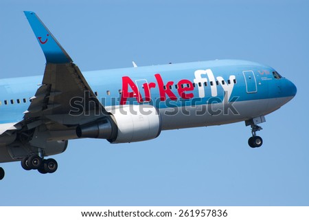 AMSTERDAM, THE NETHERLANDS--11 MARCH 2014-- Arke Fly Boeing 767 passenger airplane is lifting off from the runway.