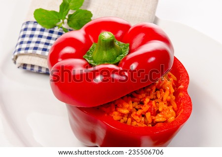 Peppers stuffed with Curried rice and selected sharpness on white plate