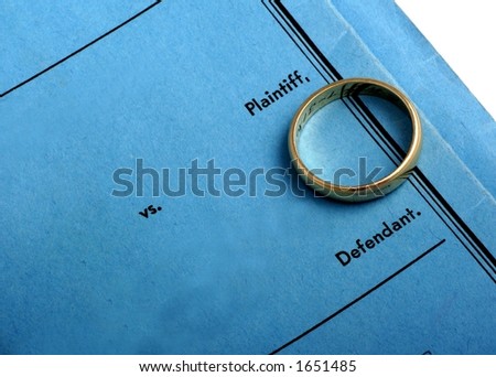 Blue divorce decree and wedding ring.
