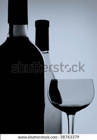 Abstract black and white photo of wine bottles and glass.
