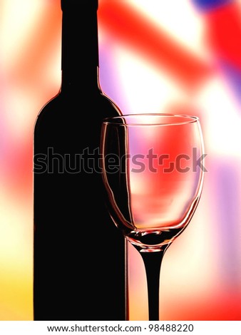 Background design made from an empty  wine glass and a black wine bottle.