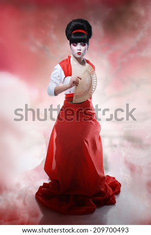 The beautiful Asian woman dances in national dress