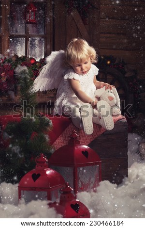 Christmas card. Christmas cute infant angel. Beautiful little girl dressed as an angel.