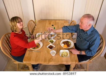 Mature couple eating dinner at home.