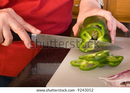 Cutting up a pepper.