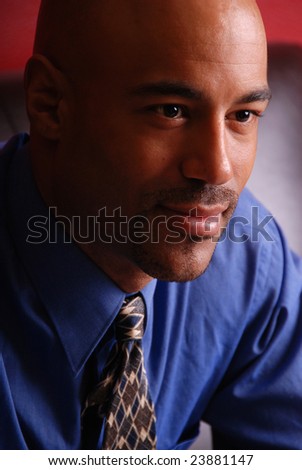Portrait of an attractive mixed race business man, wearing a blue shirt and tie.