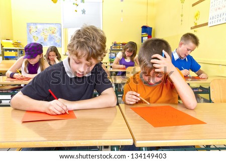 Children are doing a test in a yellow classroom at school.