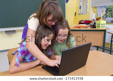 Pupils with computers in school