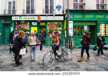 PARIS, FRANCE - OCTOBER 28, 2014: People line up at the window of a popular take-out restaurant L\'as du Fallafel on Rue des Rosiers in the Jewish neighborhood of Marais.