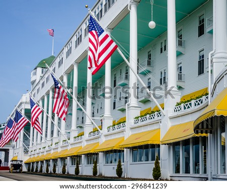 MACKINAC ISLAND, MICHIGAN - MAY 19, 2014: American flags proudly hang in front of the Grand Hotel in Northern Michigan that has been welcoming guests since 1887.