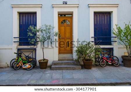 PARIS, FRANCE - AUGUST 4, 2015: Children's bicycles are parked outside of their home on Rue Cremieux in the 12th Arrondissement, one of the prettiest residential streets in the city.
