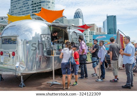 PARIS, FRANCE - AUGUST 11, 2015: Employees and visitors at the La Defense complex of government and commercial offices line up during lunch hour at a food truck selling burgers.