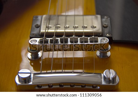 Closeup of electro-guitar bridge