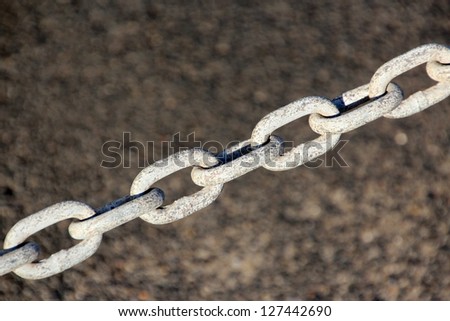 Strong metal chain used with metal poles  and  locks to secure car yards at night  against thieves .