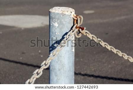 Strong metal chain used with metal poles  and  locks to secure car yards at night  against thieves .